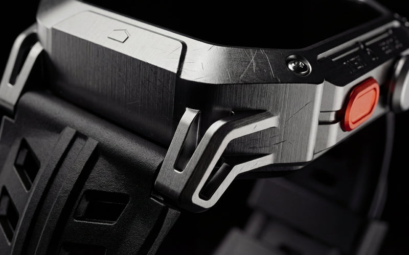 Close-up of the Njord APEX's zinc alloy case and orange side button