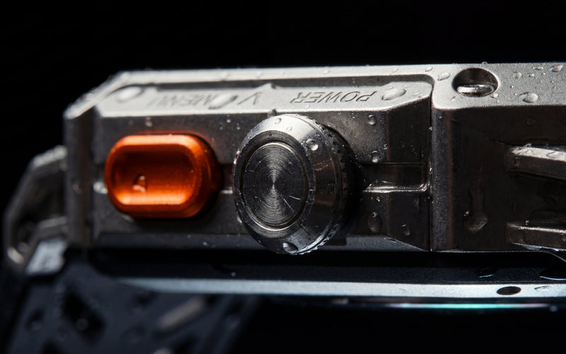 Side of the Njord APEX's zinc alloy case, showing the power button and crown